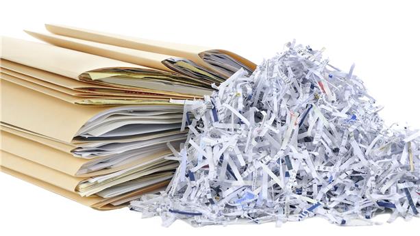 Shredded paper next to paper files
