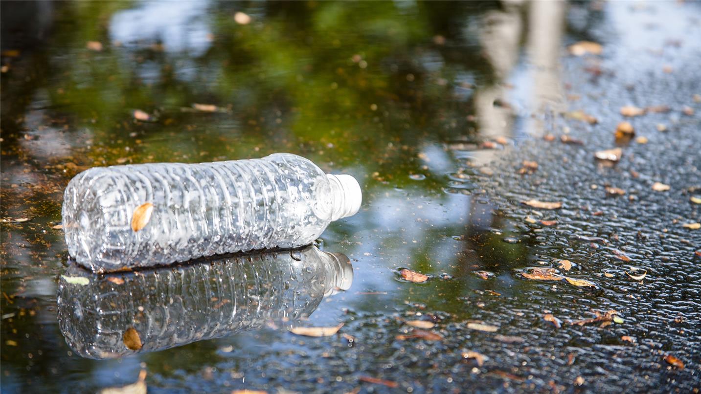 Plastic bottle in puddle 547409194 UK CW